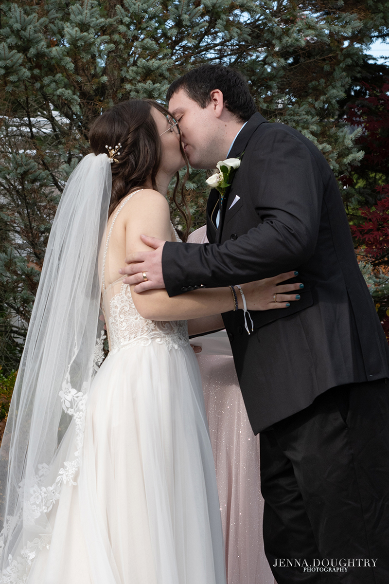 First kiss at wedding ceremony by photographer Jenna Doughtry