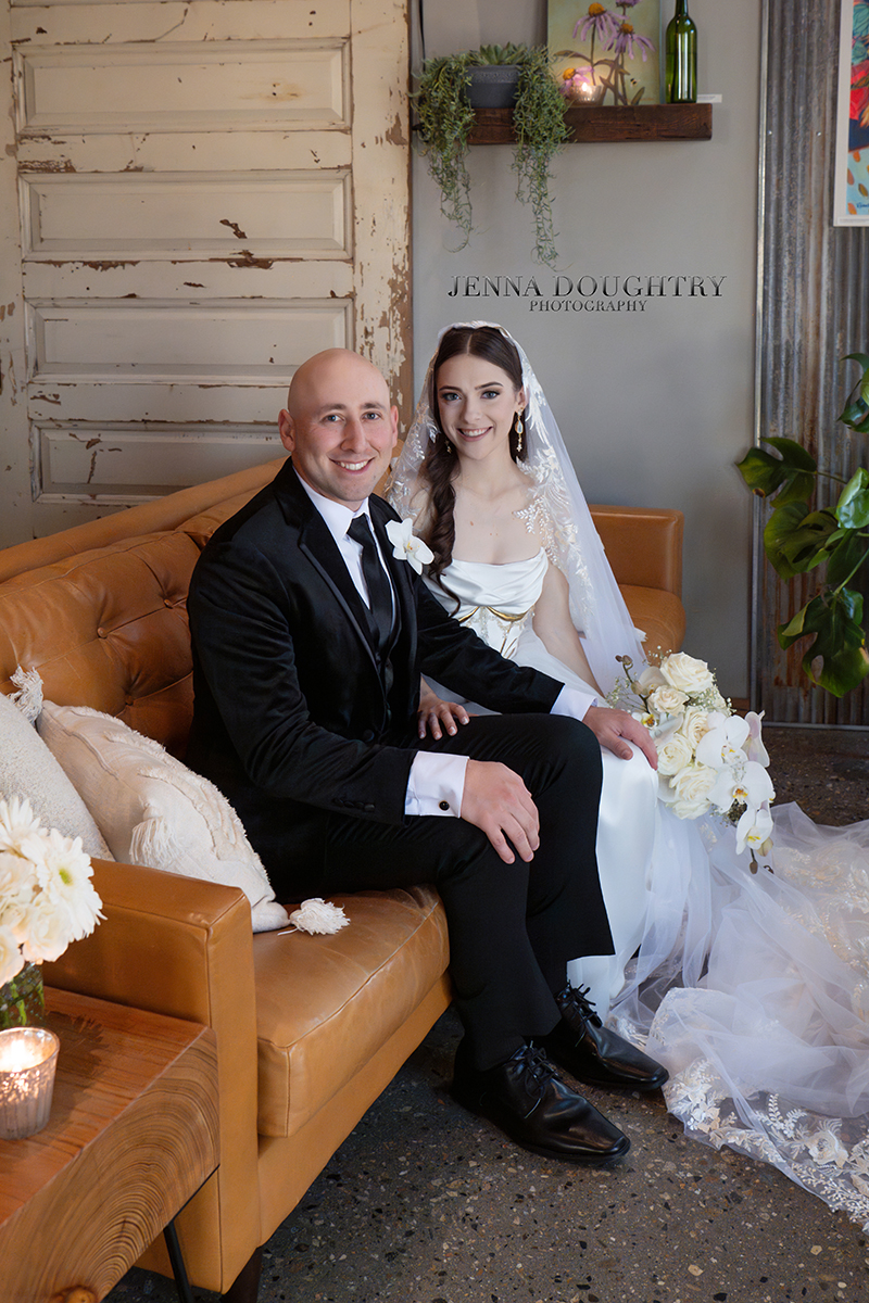 Bride and groom sitting together on a couch Wells Maine Wedding; Wild Bevy