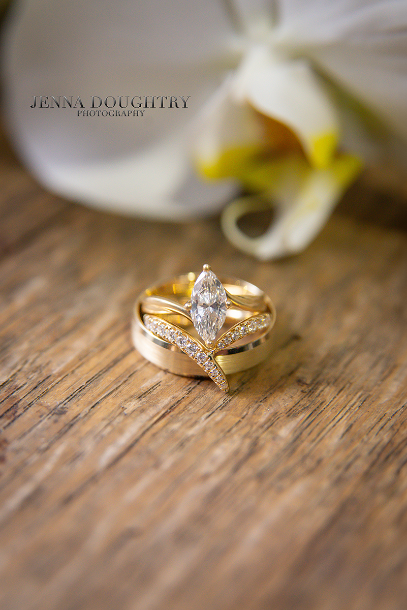 Wedding rings on a wooden table at a Wells Maine wedding